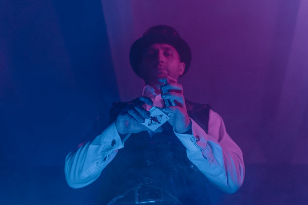 Magic show performer in front of audience with glowing effects