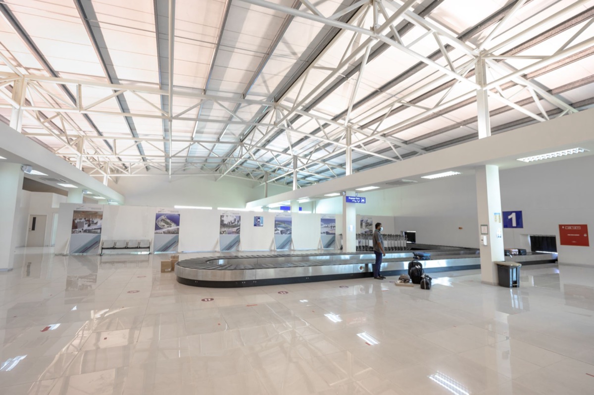 Airport terminal with escalators and baggage claim