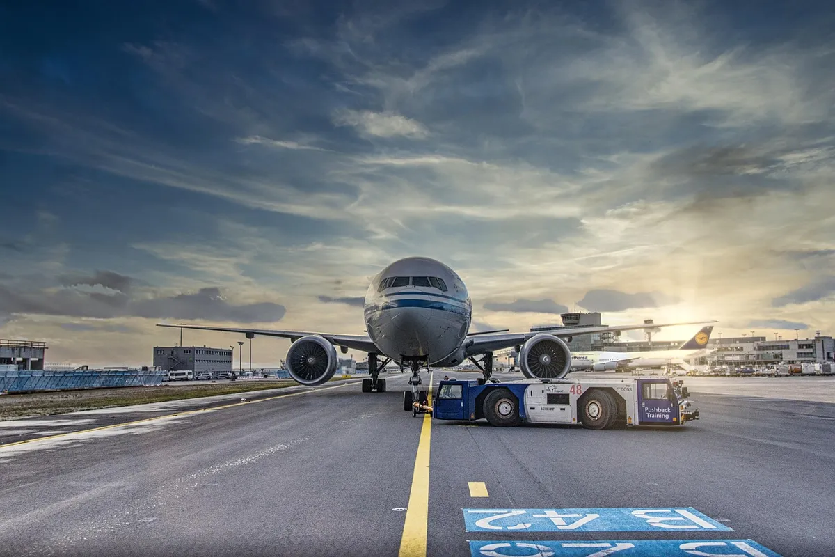 airplane, runway, airport, tarmac, aircraft, vehicle, truck, airliner, clouds, asphalt, jet, flight, transportation system, air travel, outdoor, airline, nature