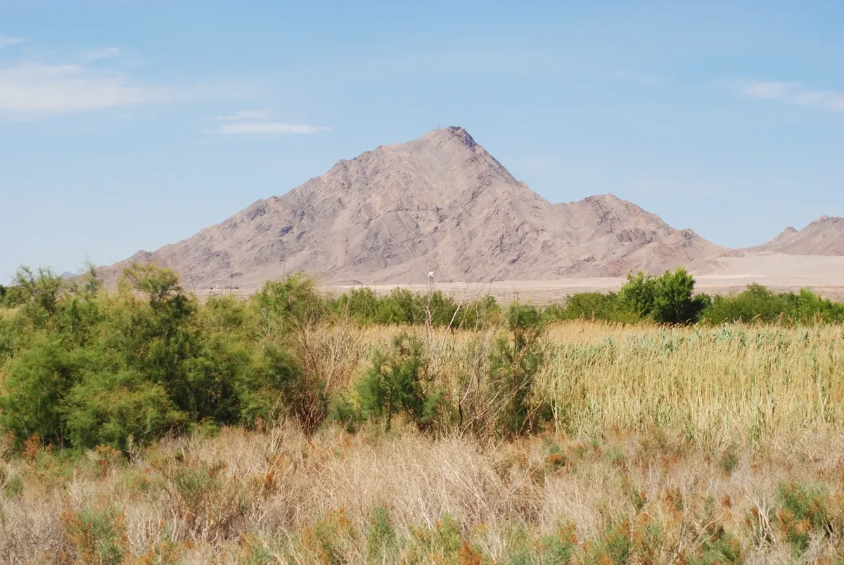 Captivating view of desert landscape with mountain, Las Vegas, Nevada, under clear summer sky.